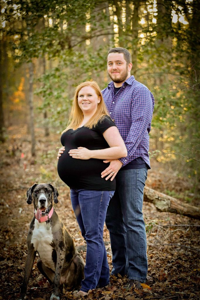 Olivia's parents pose with Big puppy sister Bella